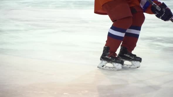 Ice Hockey. The Hockey Player Slide on Icea in Slow Motion