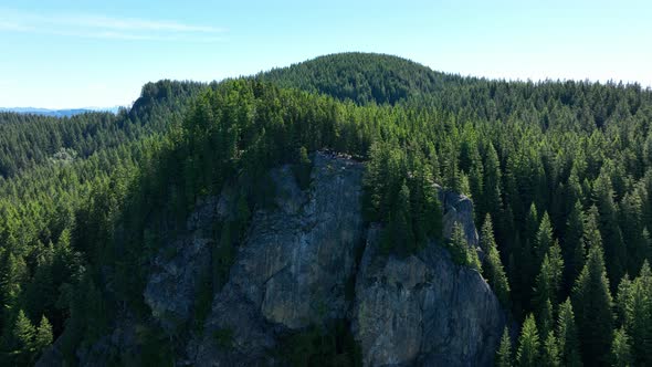 Aerial of a tree filled mountainous overlook at the end of a grueling hike; Oyster Dome in the Casca