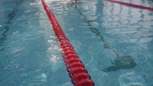 Swimmer Practicing in Pool with Blue Water