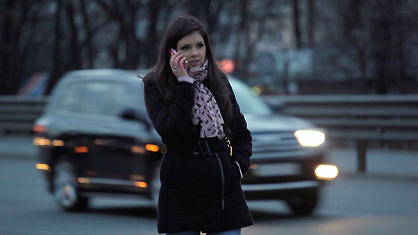 Walking Girl And Speak Mobile Phone in the Evening