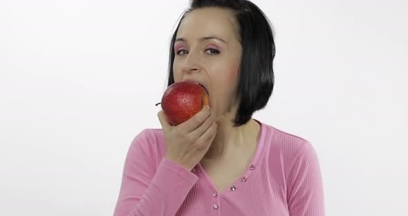 Young Woman Eating Apple and Says Yum. Girl Takes First Bite and Say Wanna Bite