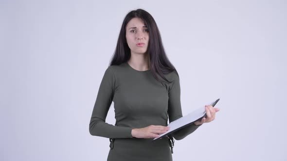 Young Stressed Woman Showing Clipboard and Giving Thumbs Down