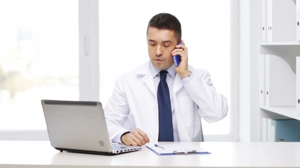 Doctor With Laptop Calling On Phone