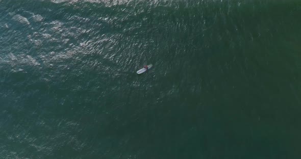 Birds eye view of surfer in the Gulf of Mexico off the coast of Lake Jackson in Texas