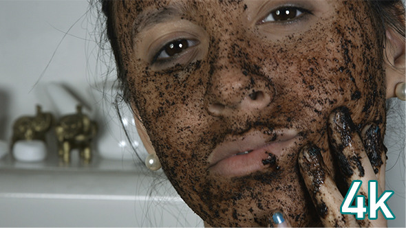 Girl Applying Cosmetic Face Mask alt