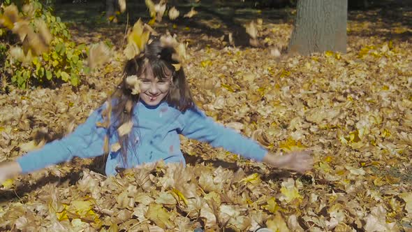 A Child Is Playing in the Autumn Park