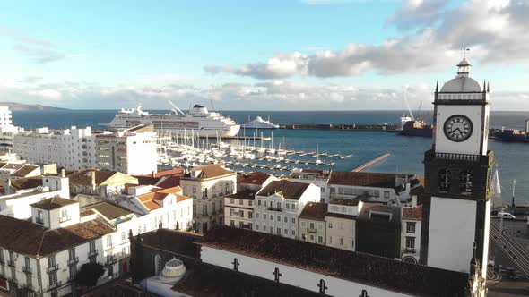 Aerial view of seaside houses with cruise ship parked off Ponta Delgada, Azores.