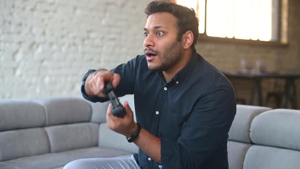 Multiethnic Hindu Guy Playing Video Game