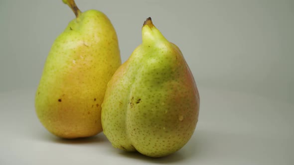 Two Delicious Freshly Picked Pear Rotating Clockwise On The Table - Close Up Shot