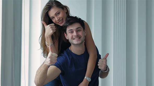 Couple In Love Pulls Things And Show A Thumbs Up