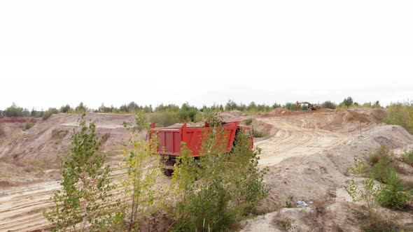 Unloaded truck is driving along iron ore quarry. Mining industry
