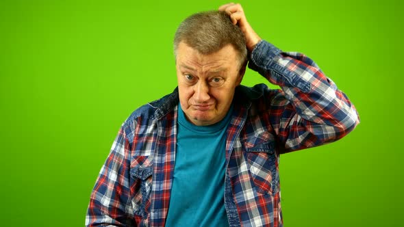 Confused Puzzled Bewildered Senior Caucasian Man in Checkered Shirt Shrugging Shoulders