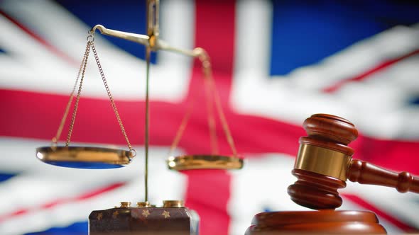 A Judge Gavel with a Flag of United Kingdom on Background