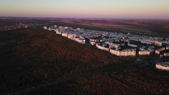 Aerial drone video of beautiful cityscape at sunset in autumn season