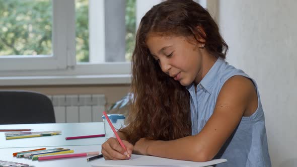 Long Haired Girl Enjoying Drawing at School Smiling To the Camera