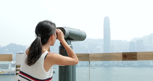 Traveler viewing tourist binocular in Hong Kong city