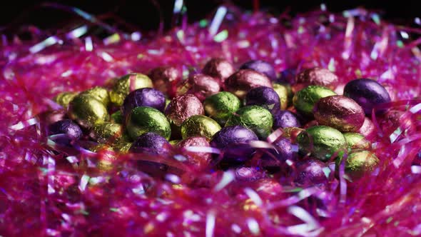 Rotating shot of colorful Easter candies on a bed of easter grass 