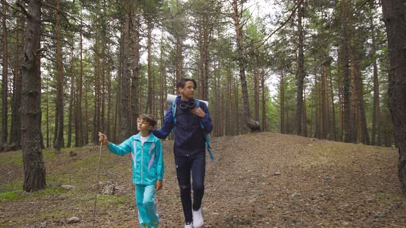 Two brothers walking in the forest. Hiking.