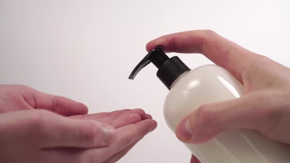 man squeezes a soap disinfectant gel 