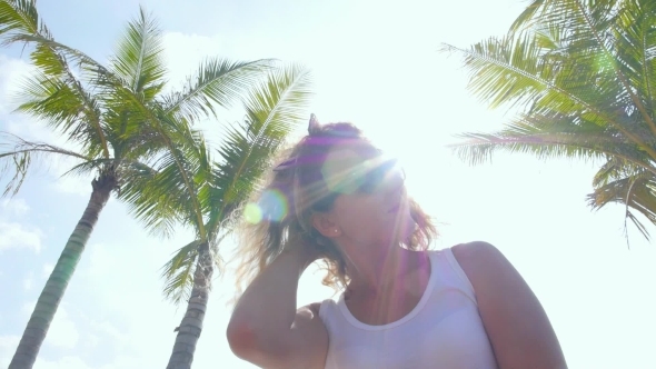 Beautiful Woman Under Palm Tree At Beach