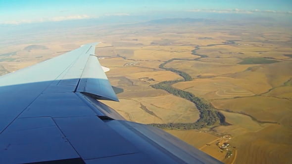 Moving land, airplaine in the sky