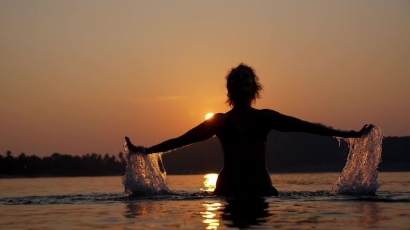 Sensual Woman Open Arms At Sunset In The Sea