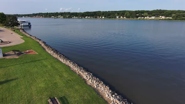 A drone shot drifting over the shoreline of the mississippi river looking north.