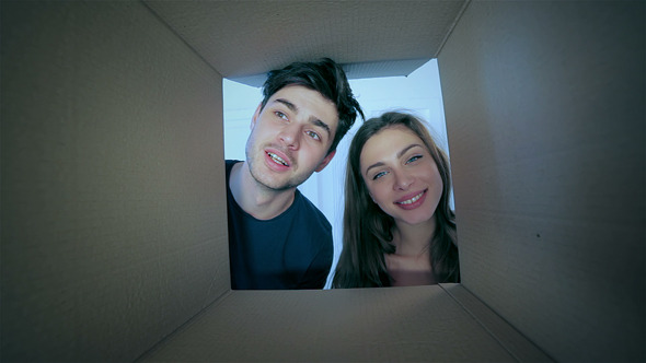 Smiling Man And Woman In Love Look Into Boxes