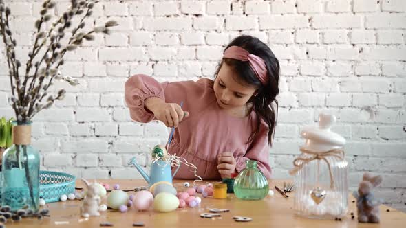 Happy Pretty Child Girl Having Fun During Painting Eggs for Easter in Spring Time at Home