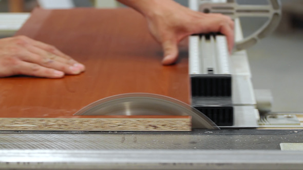 Carpenter Sawing the Wooden Desk alt