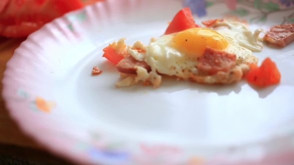 Cook Puts Fried Eggs With Vegetables In Plate