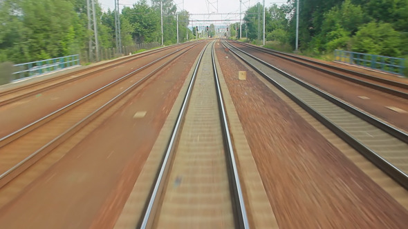 Train Moving Through Green Grassed Countryside