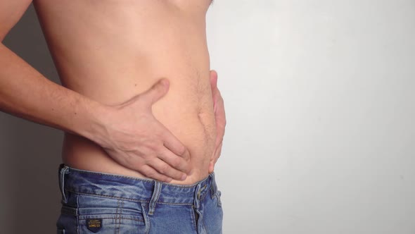male belly, overweight. man with bare fat belly shakes fat folds on his stomach