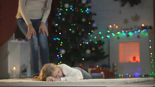 Adorable Girl Fallen Asleep Under X-Mas Tree, Happy Parents Coming and Stroking