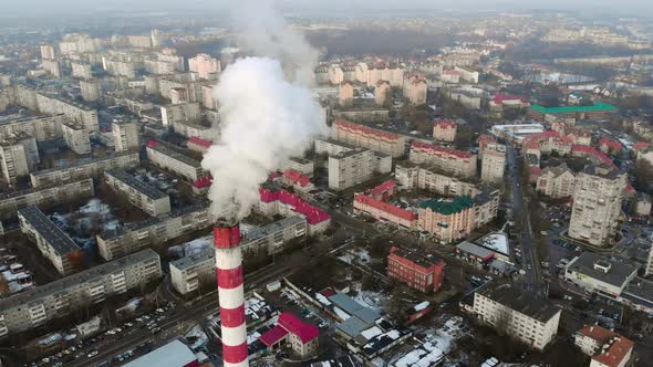 White Smoke From Industrial Chimney Over Modern City