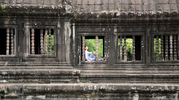Female Buddhist Meditating In Temple Window - Angkor Wat, Cambodia 2 alt