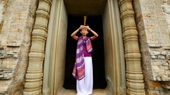 Female Buddhist Praying With Incense In Temple Doorway -   Angkor Wat Temple Cambodia 2 alt