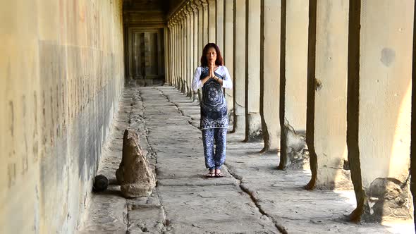 Female Buddhist With Hands In Prayer In Temple Hallway  - Angkor Wat Temple Cambodia alt