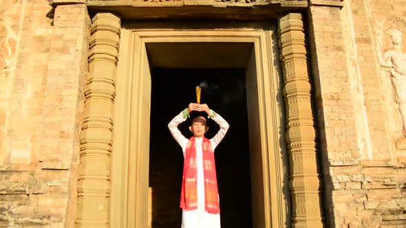 Female Buddhist Praying With Incense In Temple Doorway -   Angkor Wat Temple Cambodia 4 alt