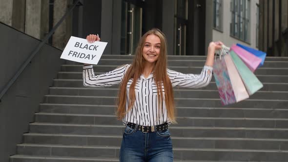 Joyful Teen Girl Showing Black Friday Inscription, Smiling, Looking Satisfied with Low Prices