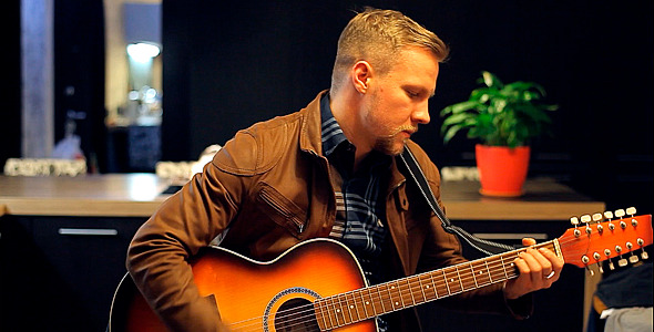 Man Playing Solo an Acoustic Guitar alt