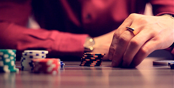 Man Playing Online Poker and Moves Chips.