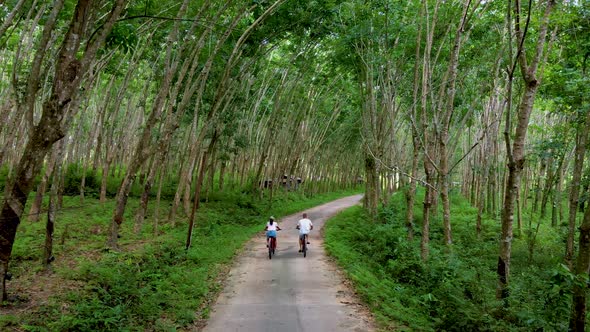 Couple Men and Woman on Bicycle in the Jungle of Koh Yao Yai Thailand Men and Woman Bicycling