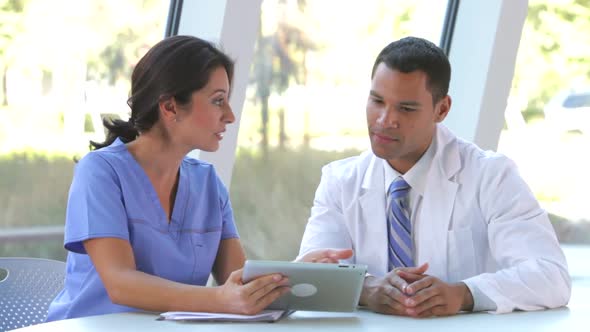 Medical Staff Review Information On Digital Tablet