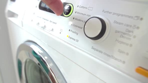 Man Putting Laundry Into Washing Machine 2