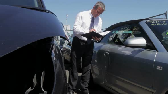 Loss Adjuster Inspecting Car Involved In Accident 1