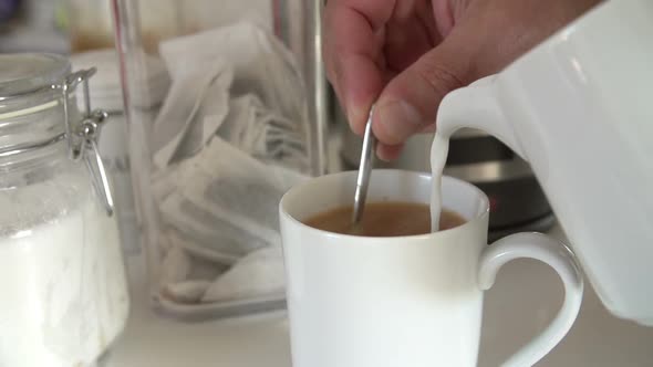  Adding Milk To Cup Of Tea