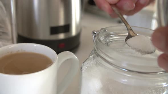 Adding Sugar To Cup Of Tea