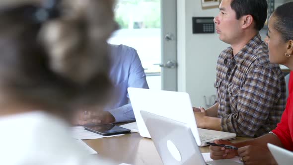 Architects Sitting Around Table Having Meeting 5