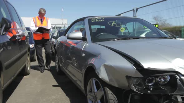 Loss Adjuster Inspecting Car Involved In Accident 7